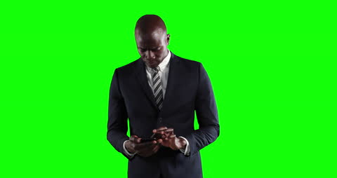 Businessman Using Smartphone on Vibrant Green Screen