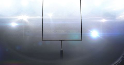 Goalposts Under Night Lights in Football Stadium