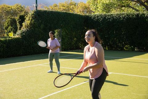 Diverse Women Enjoying Tennis Practice on Sunny Day