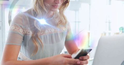 Female Professional Using Smartphone in Bright Workspace