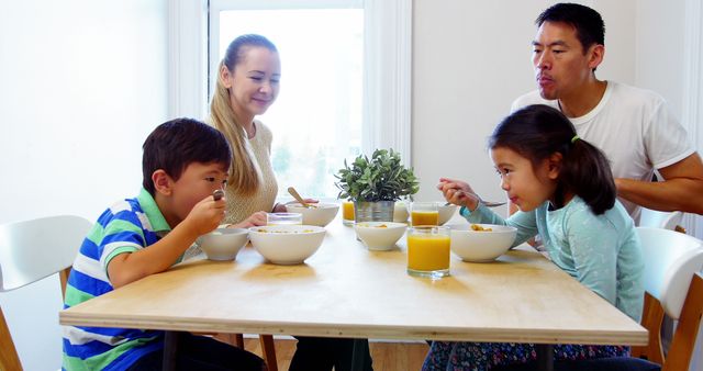 Happy Family Having Breakfast Together With Kids Eating Cereal - Download Free Stock Images Pikwizard.com