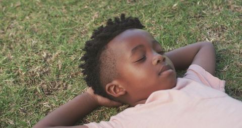 African American Boy Relaxed on Grass Embracing Peaceful Moment - Download Free Stock Images Pikwizard.com