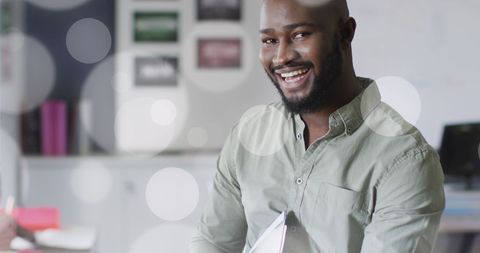 African American Teacher Smiling in Classroom Holding Tablet