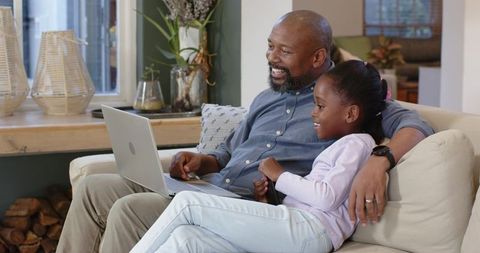 African American Father and Daughter Enjoying Laptop Time at Home