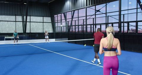 Energetic Match on Indoor Paddle Tennis Court with Friends