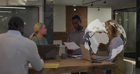 Team Collaboration Around Table with Technology and Documents