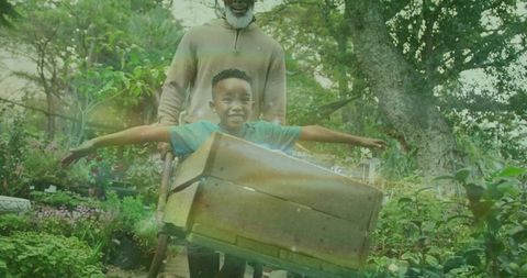 Grandfather and grandson bonding during outdoor garden playtime