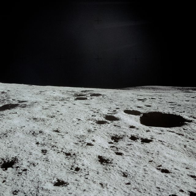 AS14-66-9244 (5-6 Feb. 1971) --- An excellent view of the lunar terrain looking through the right window of the Lunar Module (LM), photographed by one of the Apollo 14 astronauts during their stay on the lunar surface. Pothole-sized craters can be seen in the foreground. While astronauts Alan B. Shepard Jr., commander, and Edgar D. Mitchell, lunar module pilot, descended in the LM to explore the moon, astronaut Stuart A. Roosa, command module pilot, remained with the Command and Service Modules (CSM) in lunar orbit.