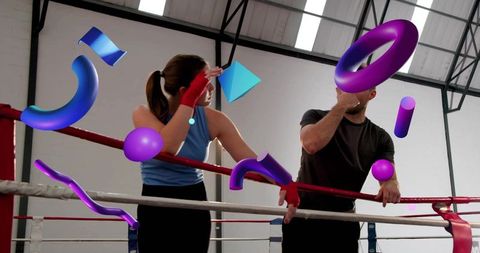 Leaning couple resting on boxing ring ropes training with vibrant 3D geometric shapes