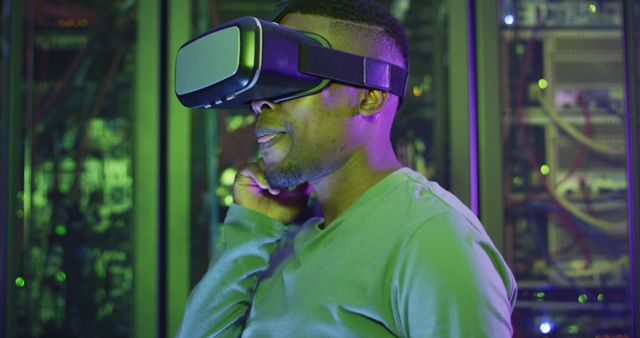 African american male computer technician using vr headset working in business server room - Download Free Stock Photos Pikwizard.com