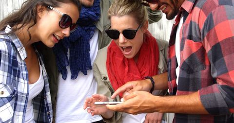 Enthusiastic Group of Friends Reacting to Smartphone Content