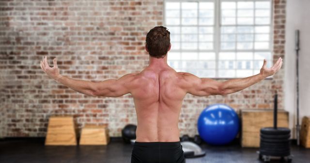 Rear view of a shirtless man flexing his muscles in the gym 4k