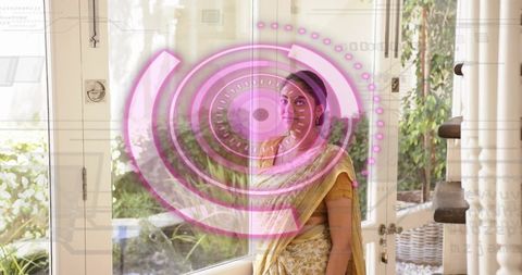 Indian woman wearing pale yellow saree standing by glass doors with pink holographic ui