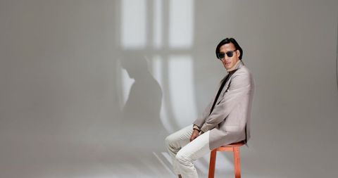 Stylish man in gray blazer and sunglasses with minimalist vibe