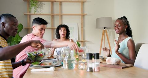 Friends Sharing a Homemade Meal in Cozy Dining Setting