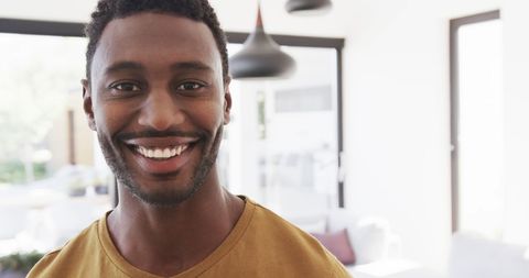 Smiling African American Man at Home in Sunlit Living Room - Download Free Stock Images Pikwizard.com