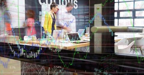 Team collaborating with stock trade graphics in modern office