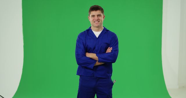 Smiling Worker in Blue Uniform Standing in Front of Green Screen - Download Free Stock Images Pikwizard.com