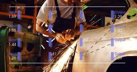 Mechanic grinding car panel sending sparks with data overlay in industrial workshop