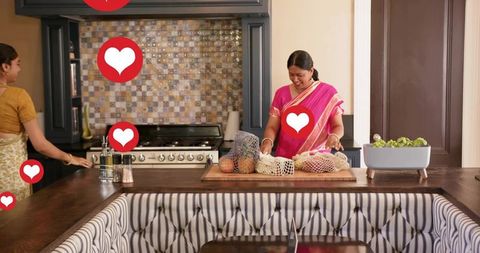 Mother and daughter sorting produce on kitchen island with reusable mesh bags prepping meal