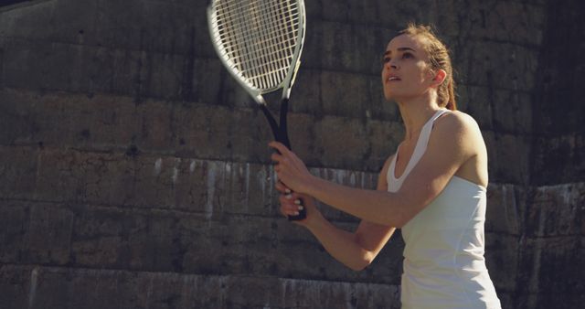 Young Woman Playing Tennis Outdoors Focusing On Game - Download Free Stock Images Pikwizard.com