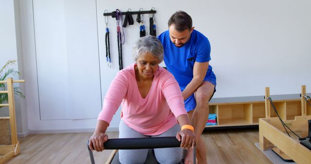 Senior Woman Receiving Assistance During Pilates Exercise - Download Free Stock Images Pikwizard.com