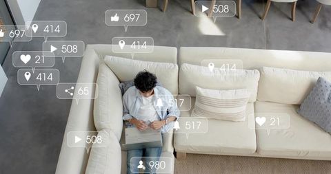 Remote worker on l-shaped sofa using laptop with social media engagement overlays