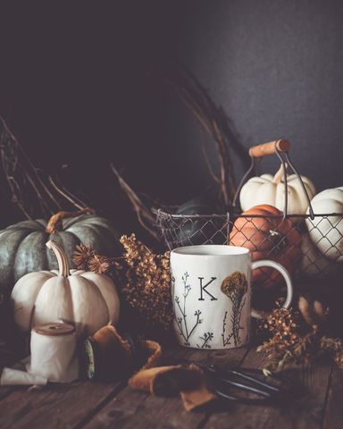 Autumn still life with pumpkins and hot beverage mug
