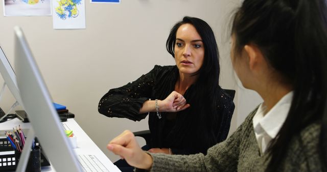 Businesswoman Collaborating with Colleague in Modern Office - Download Free Stock Images Pikwizard.com