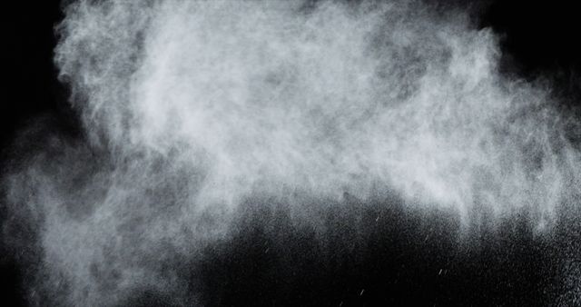 A cloud of white powder bursts against a dark background, with copy space. The contrast of the powder's fine particles creates a dramatic and dynamic visual effect.