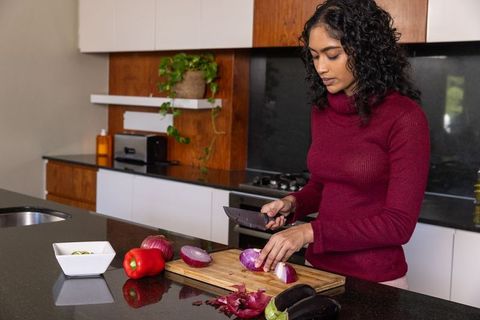 Woman slicing onion in sleek modern kitchen