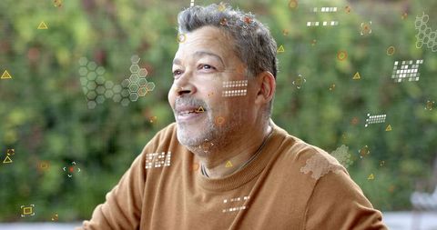 Senior man relaxing on patio looking up with augmented reality overlays