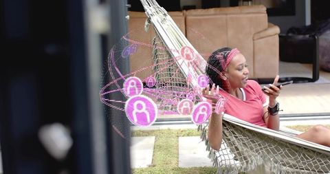 Young woman relaxing in hammock talking on smartphone with social network ar overlay