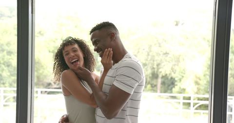 Joyful Couple Relaxing and Laughing at Home