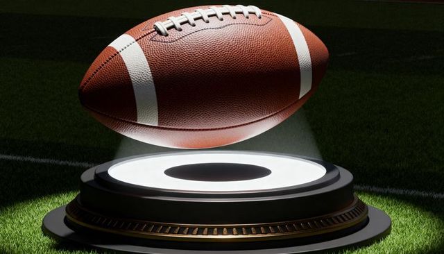 Levitating american football hovering above illuminated pedestal on stadium turf