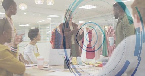 Fashion Designer Discussing Red and White Top in Creative Studio