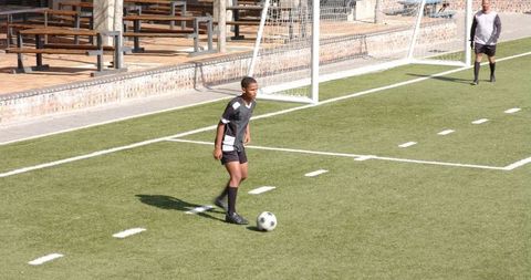 Youth Soccer Players Competing Vigorously on a Green Field