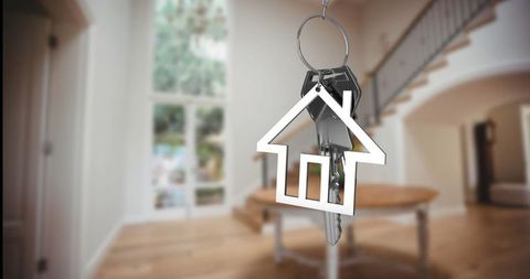House-Shaped Keychain in Elegant Foyer with Lofty Staircase