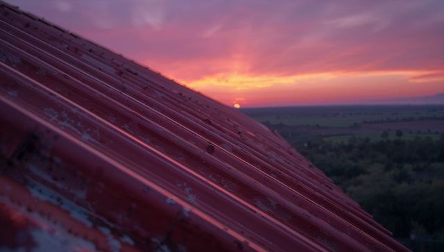 Vibrant Sunset Casting Colors Over Corrugated Rooftop