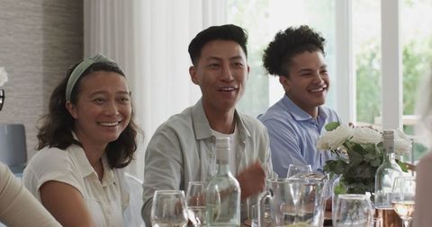 Friends Celebrating with Laughter at a Festive Wedding Reception