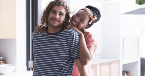 Happy Couple Embracing in Bright Kitchen