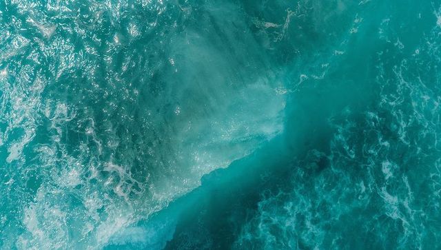 Aerial view finedited's blue waves dancing over deep ocean waters