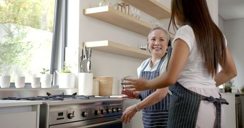 Grandmother and Granddaughter Baking in a Modern Kitchen
