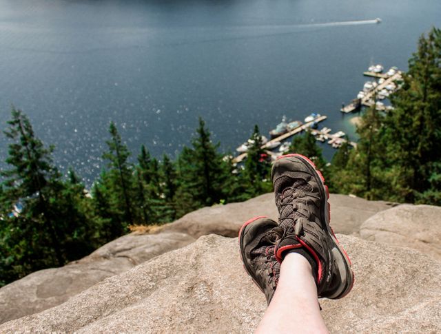 Hiker Resting on Rocky Summit Overlooking Scenic Lake View - Download Free Stock Images Pikwizard.com