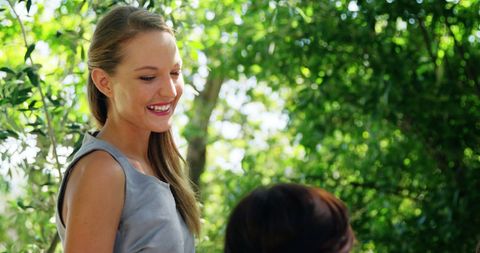 Cheerful Woman Enjoying Sunny Restaurant Garden Gathering - Download Free Stock Images Pikwizard.com