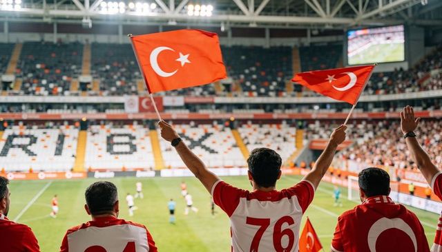 Turkish football fans waving national flags in stadium stands cheering team