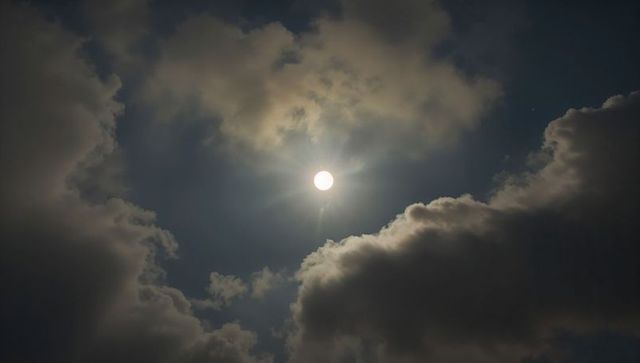 Luminous Sun Through Dramatic Cumulus Clouds at Twilight