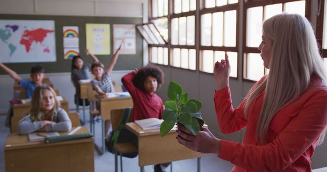 Teacher Discussing Plant with Attentive Students in Classroom - Download Free Stock Images Pikwizard.com