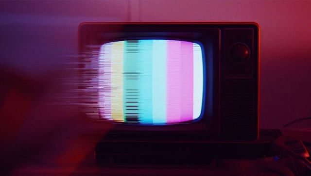 Vintage CRT TV with Color Bar Glitch in Retro Setting