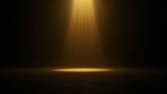 Warm Overhead Spotlight Casting Circular Glow on Textured Stage Floor